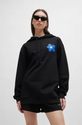 Cotton-terry all-gender hoodie with flower-print logos