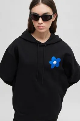 Cotton-terry all-gender hoodie with flower-print logos