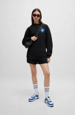 Cotton-terry all-gender hoodie with flower-print logos